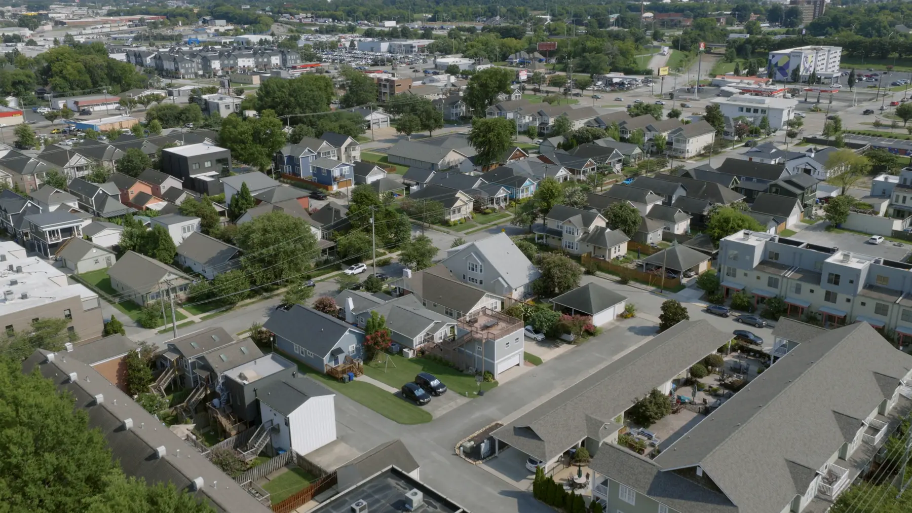 Aerial view of a mature residential neighborhood with tree-lined streets